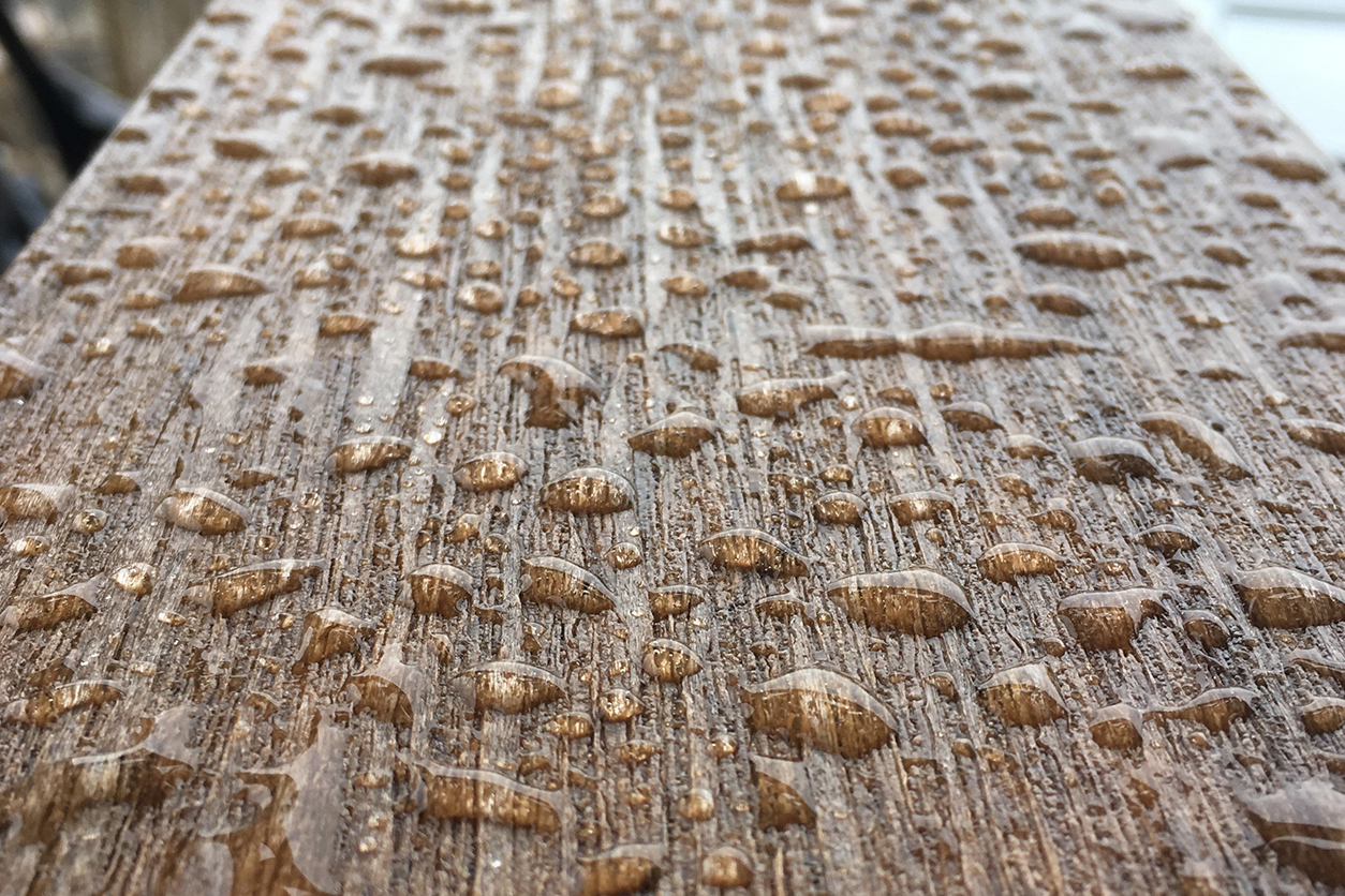A HDPE board is shown up-close with water drops on it.